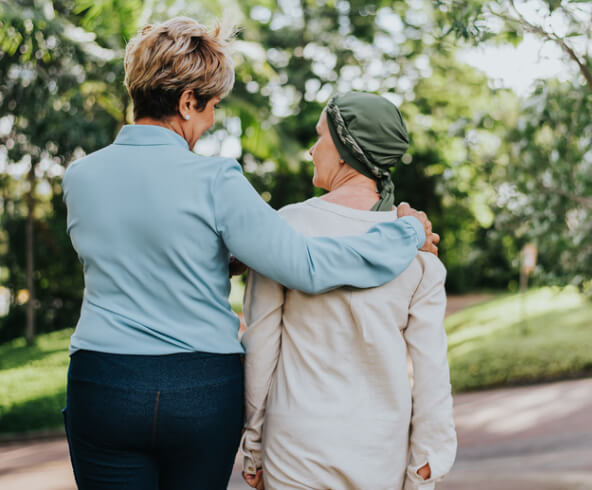 Elderly woman shaking hands with man sitting on couch